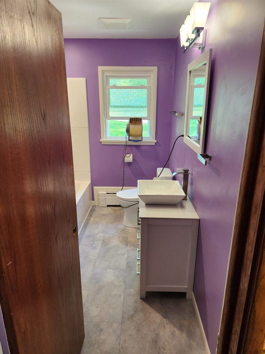 Bathroom remodel with new floor, by New West Co