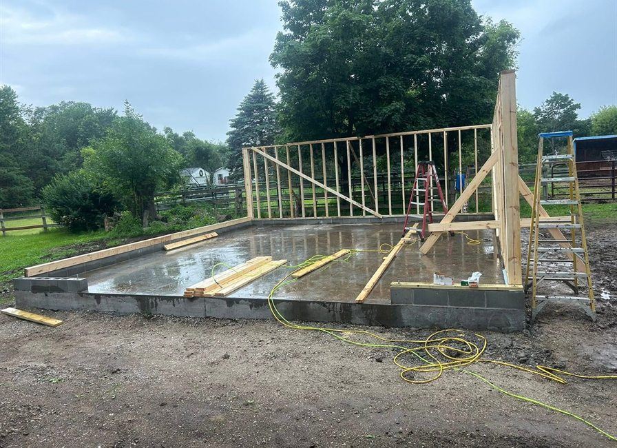 Garage walls going up on the slab, by New West Co