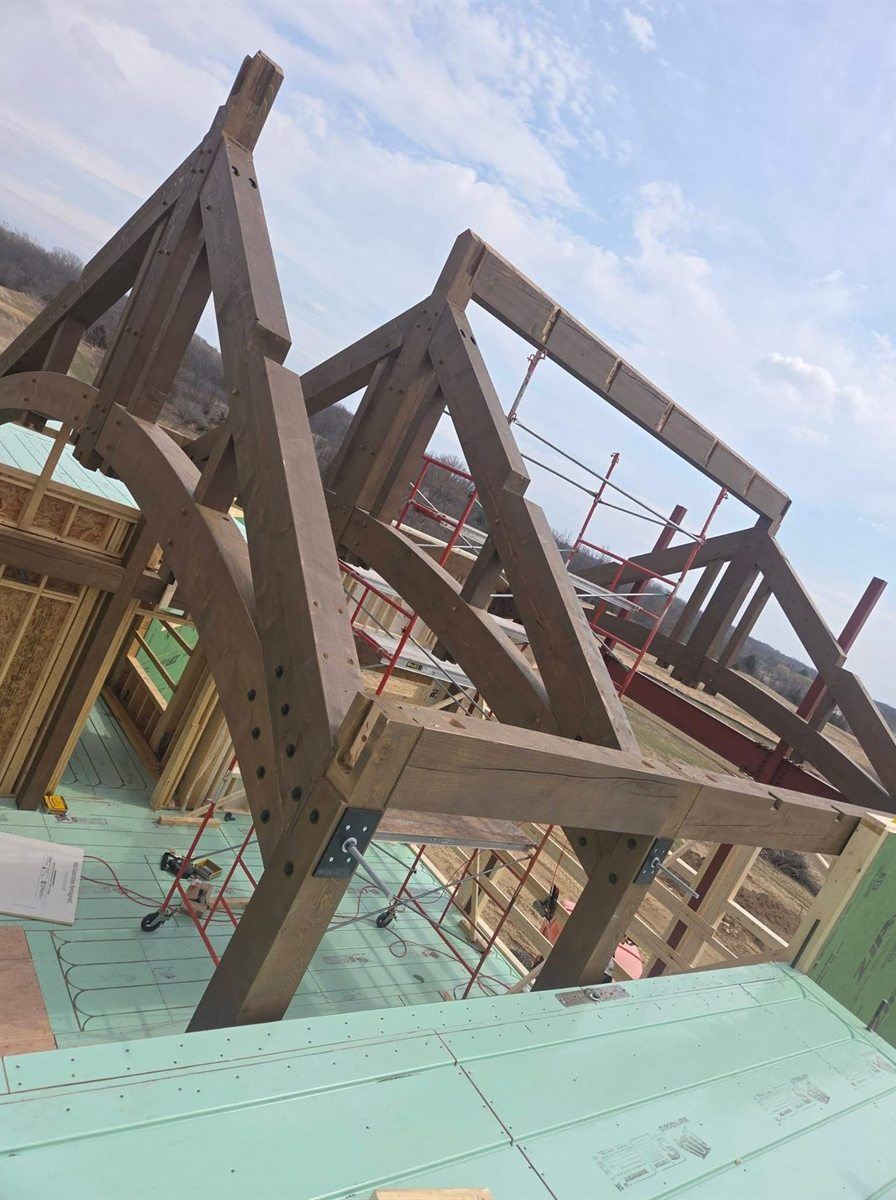 Timber truss with curved braces, by New West Co