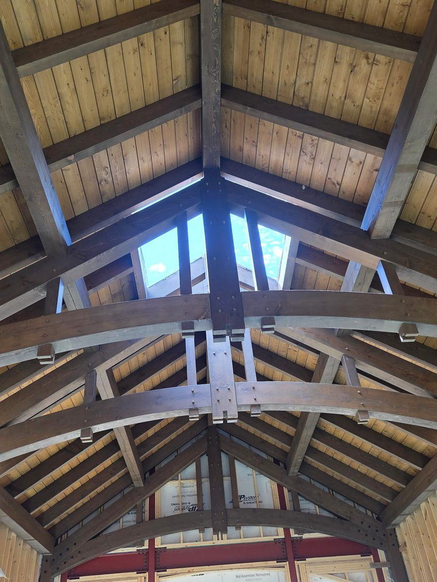 Timber frame ceiling with curved braces, built by New West Co