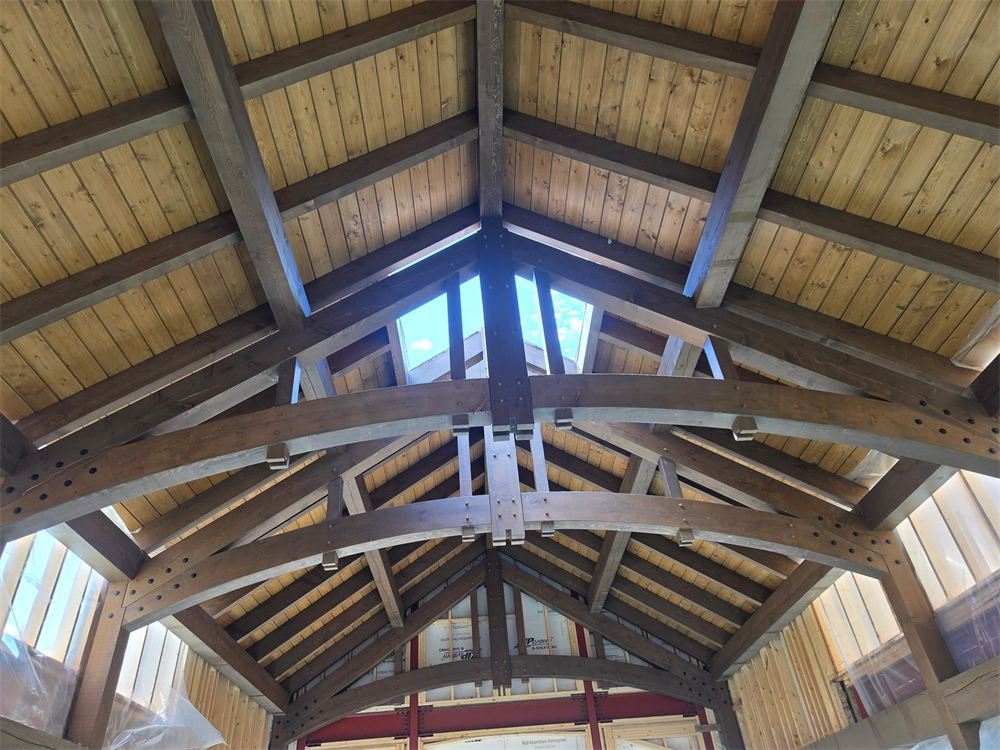 Timber frame ceiling with arched trusses, by New West Co