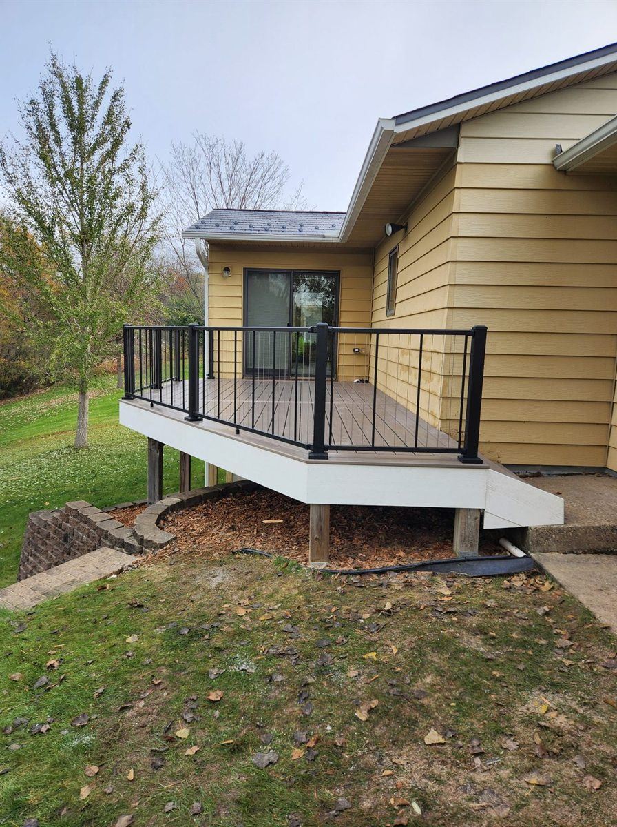 Raised composite deck on a split level home, by New West Co