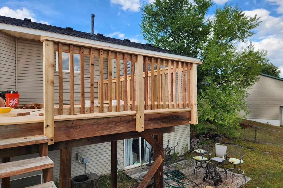 Raised deck with new cedar railing, by New West Co