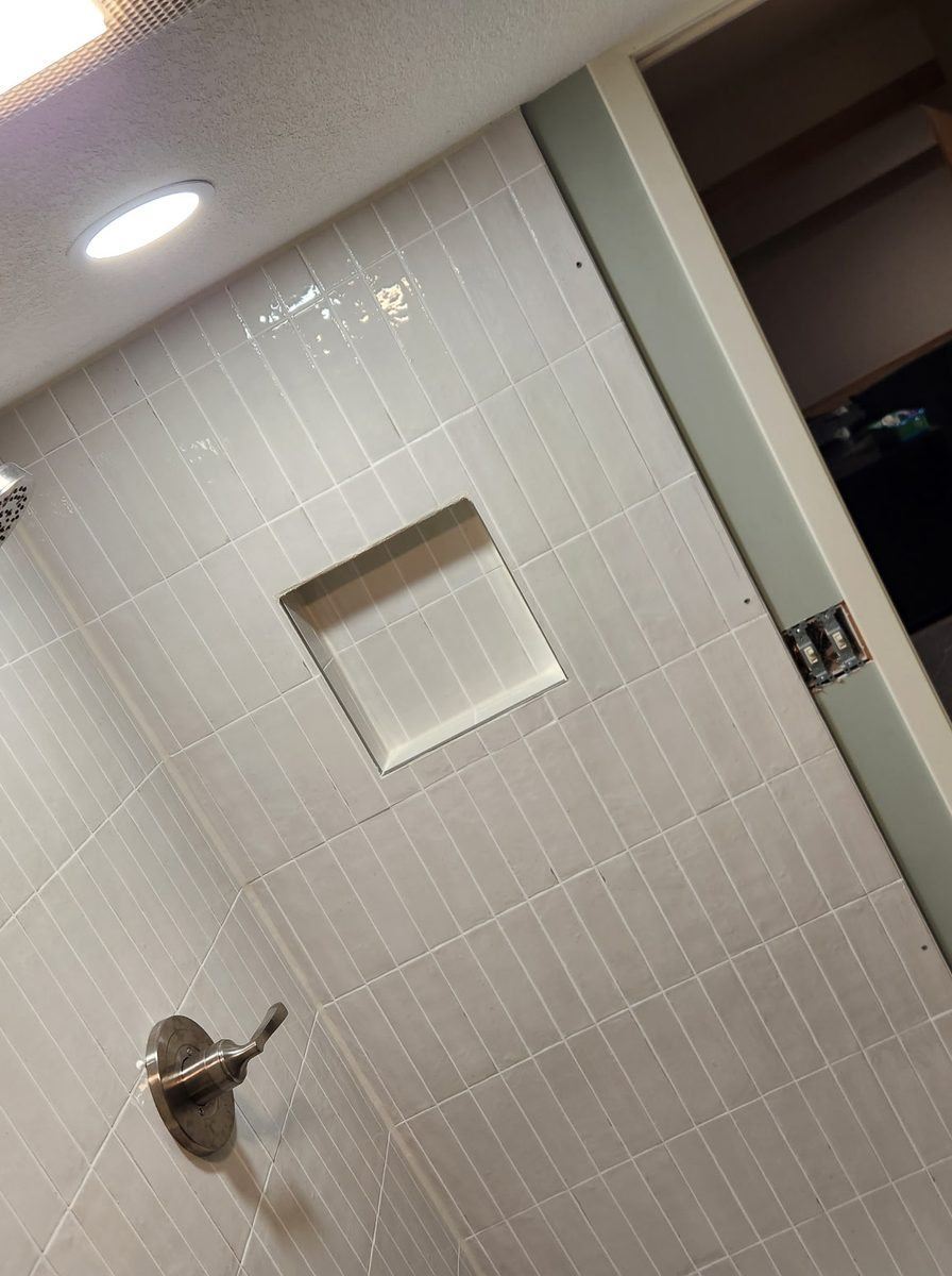 Tiled shower with niche, by New West Co