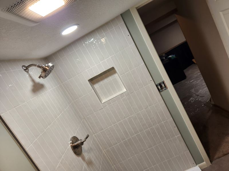 Tiled shower with niche, by New West Co