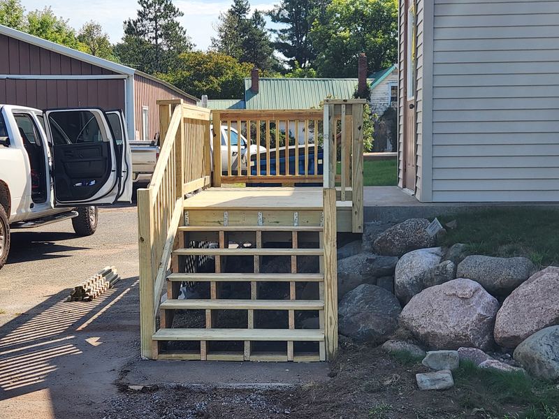 Wood deck stairs and railing, by New West Co