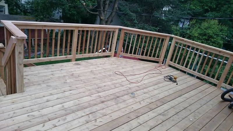 Wood deck boards and railing, by New West Co