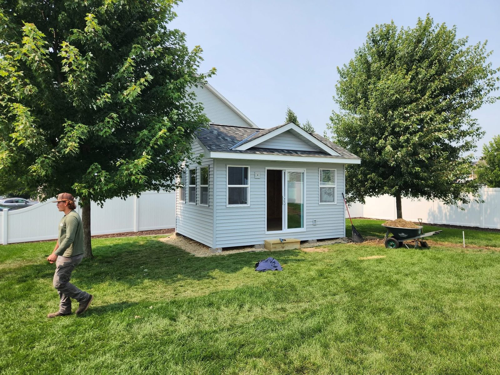 Finished backyard studio with a sliding door