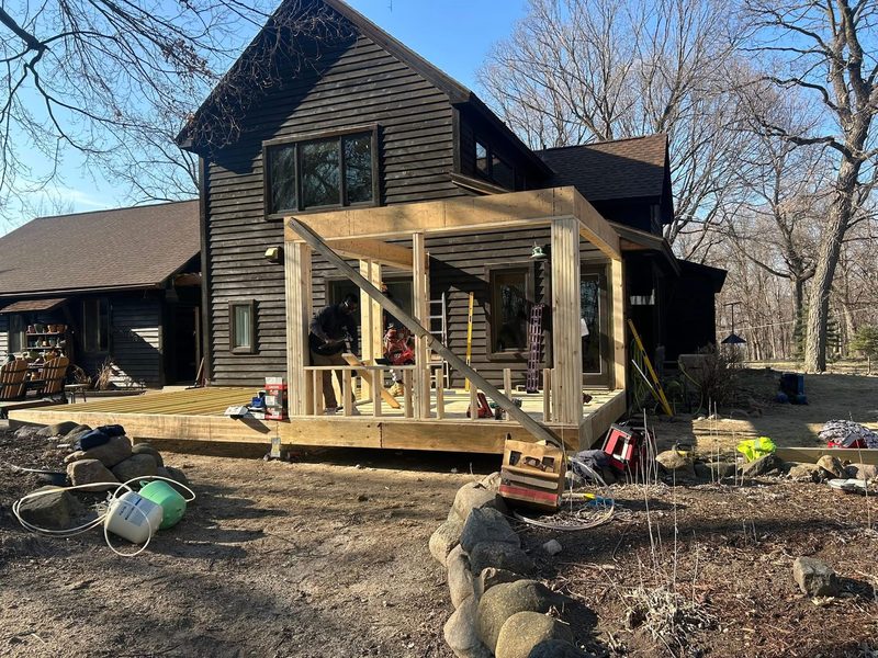Covered porch framing on a cedar home, by New West Co