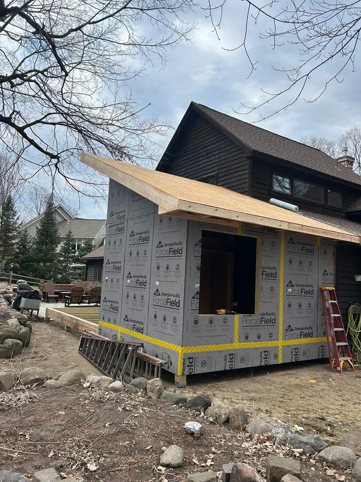 Home addition wrapped and roofed, by New West Co