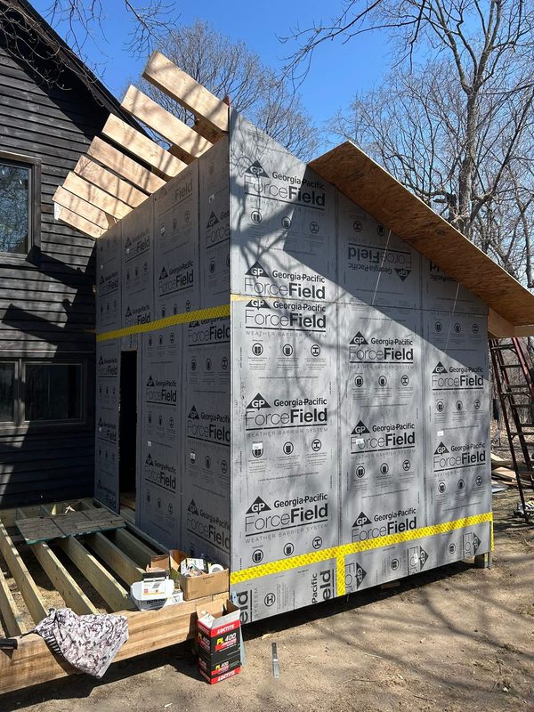 Addition wall with house wrap, by New West Co
