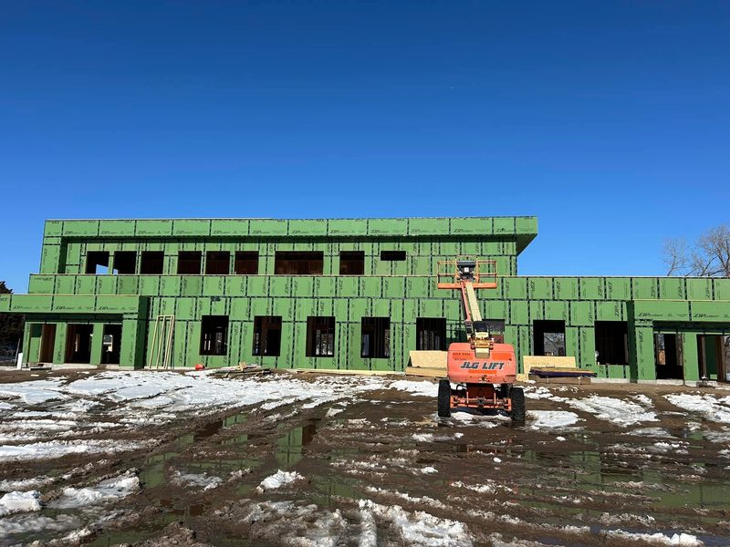 Commercial building sheathed in winter, by New West Co